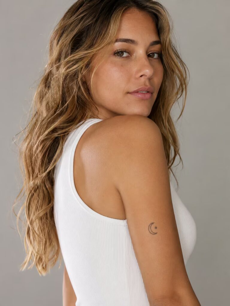 A Crescent Moon Cradling a Single Star on the Upper Arm