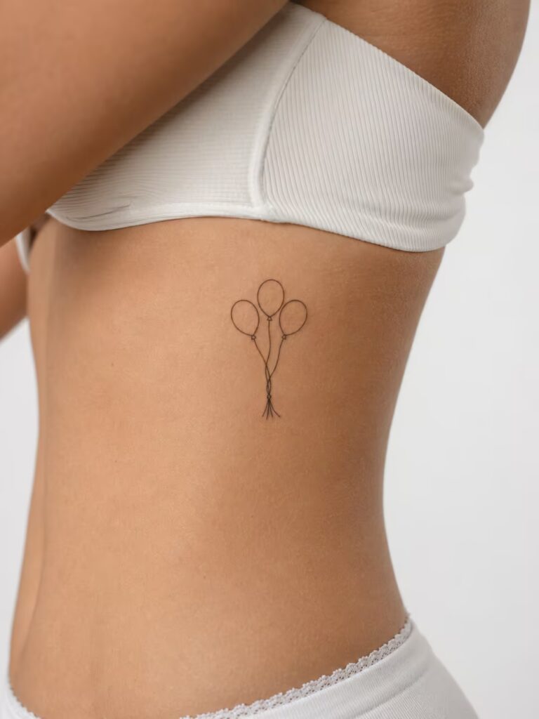 A Small Bestie Tattoo of Three Balloons from One Knot on the Ribcage