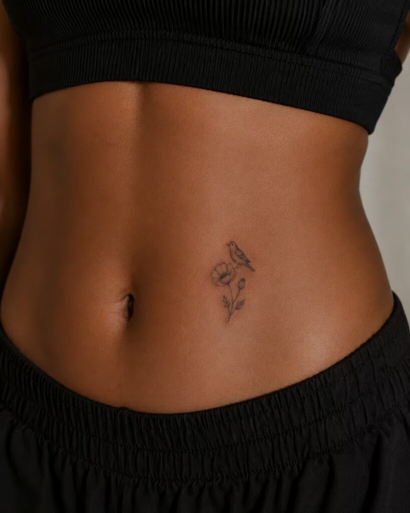 Bird and Poppy, Lower Stomach bird tattoo with flower designs